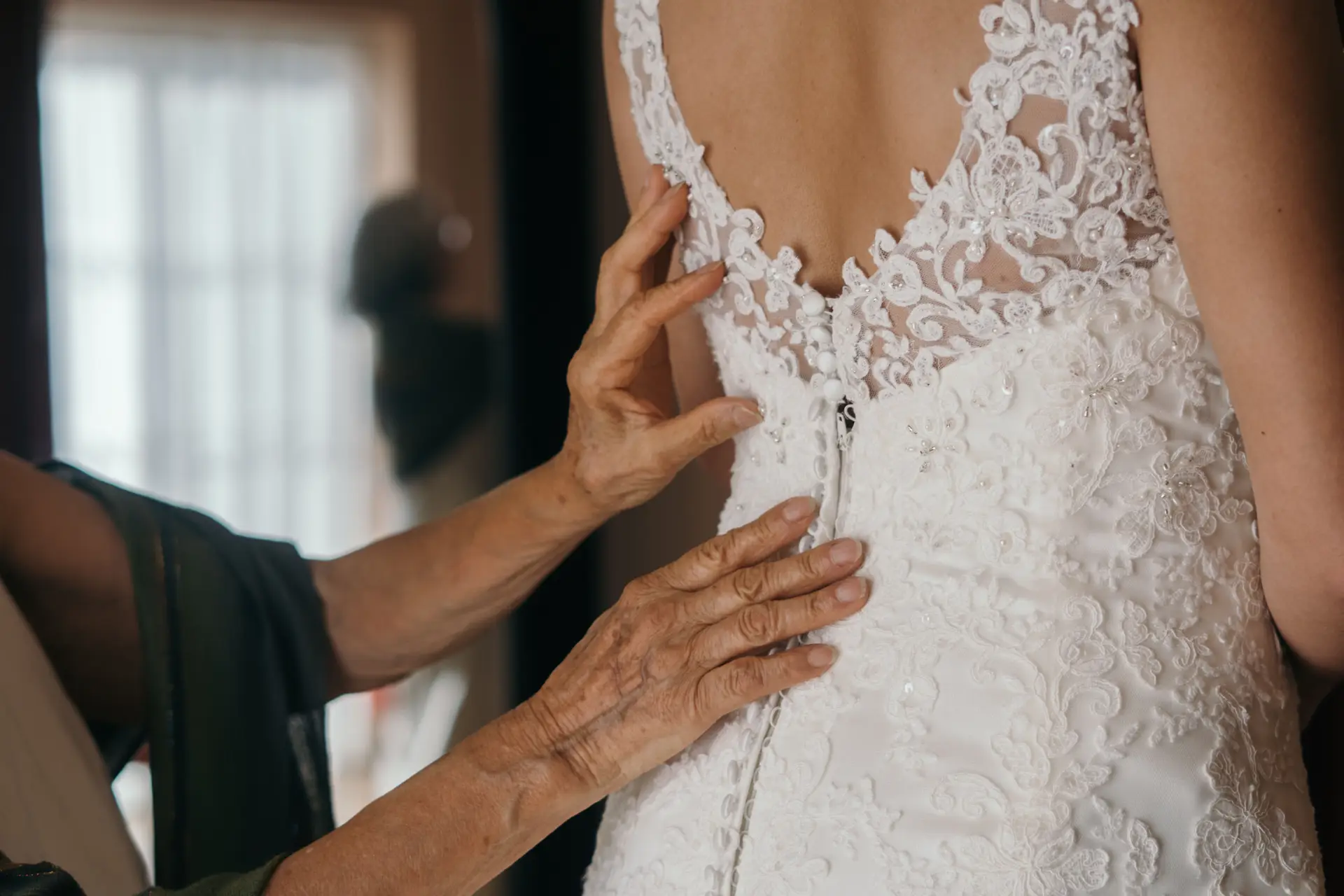 Seamstress working on bridal gown